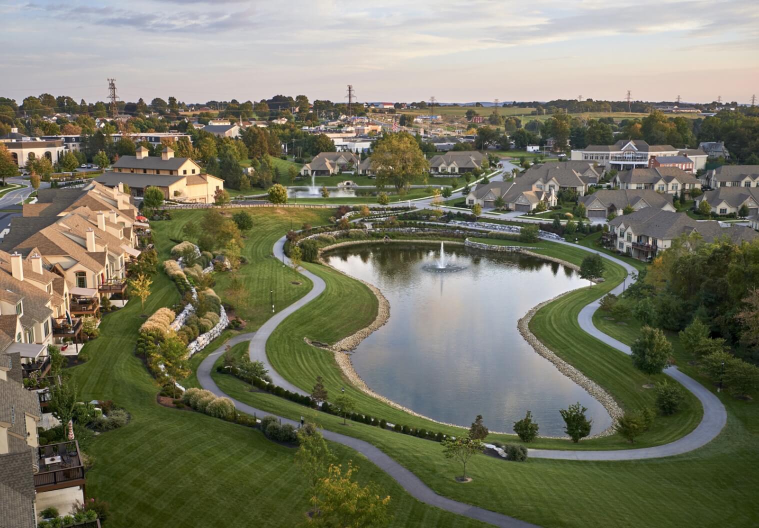 An aerial view of a retirement community with a pond.