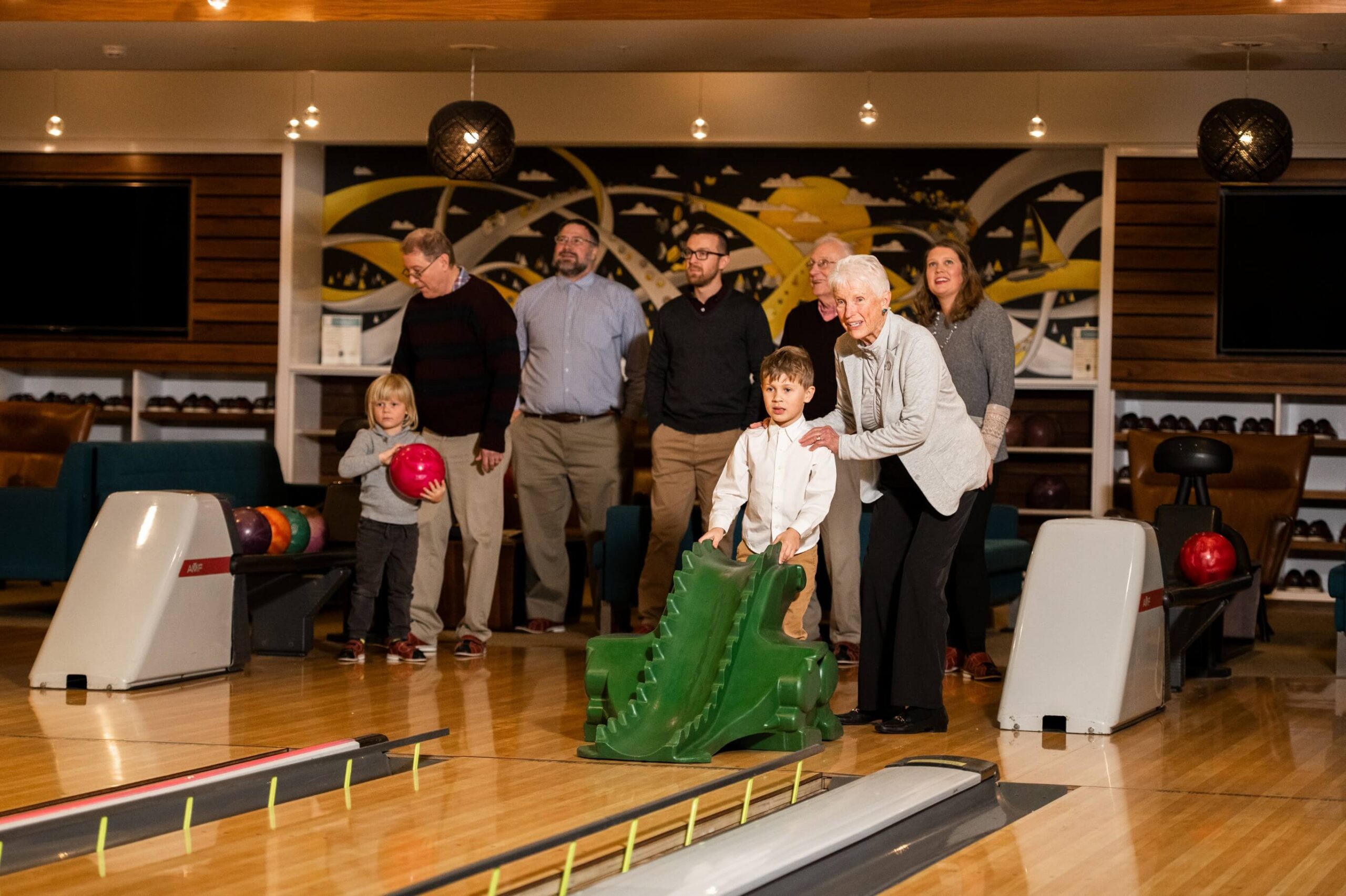 A group of seniors enjoying a friendly bowling game in an independent living community.