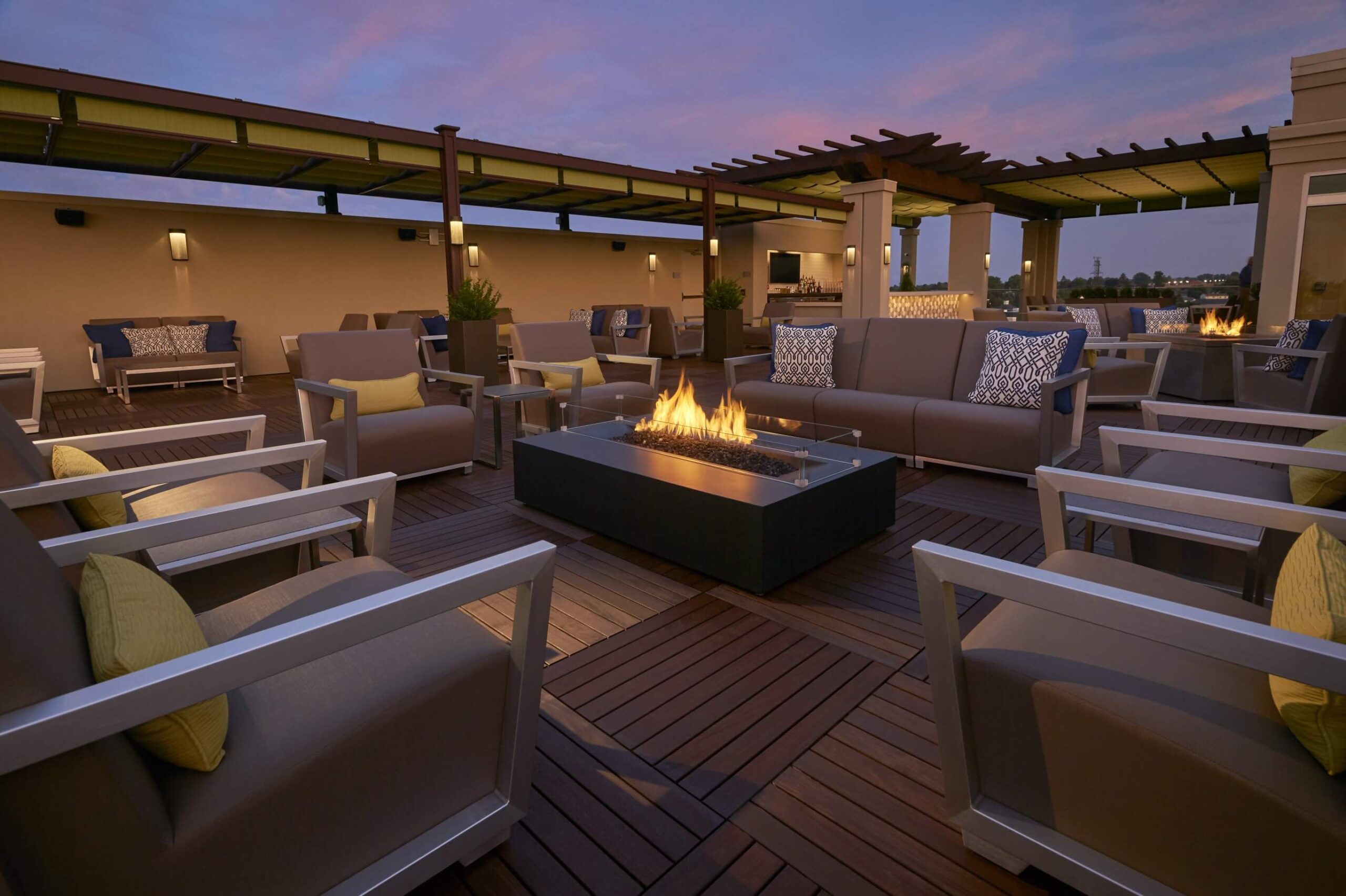 A serene patio oasis at dusk in a retirement community, designed exclusively for seniors 55+.