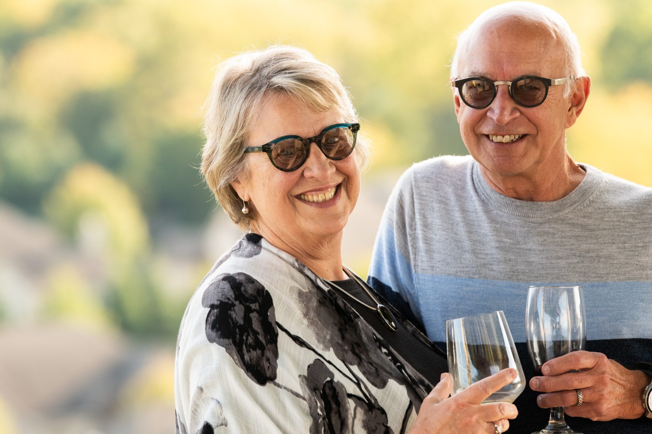 An older couple enjoying wine glasses in a Retirement Community.